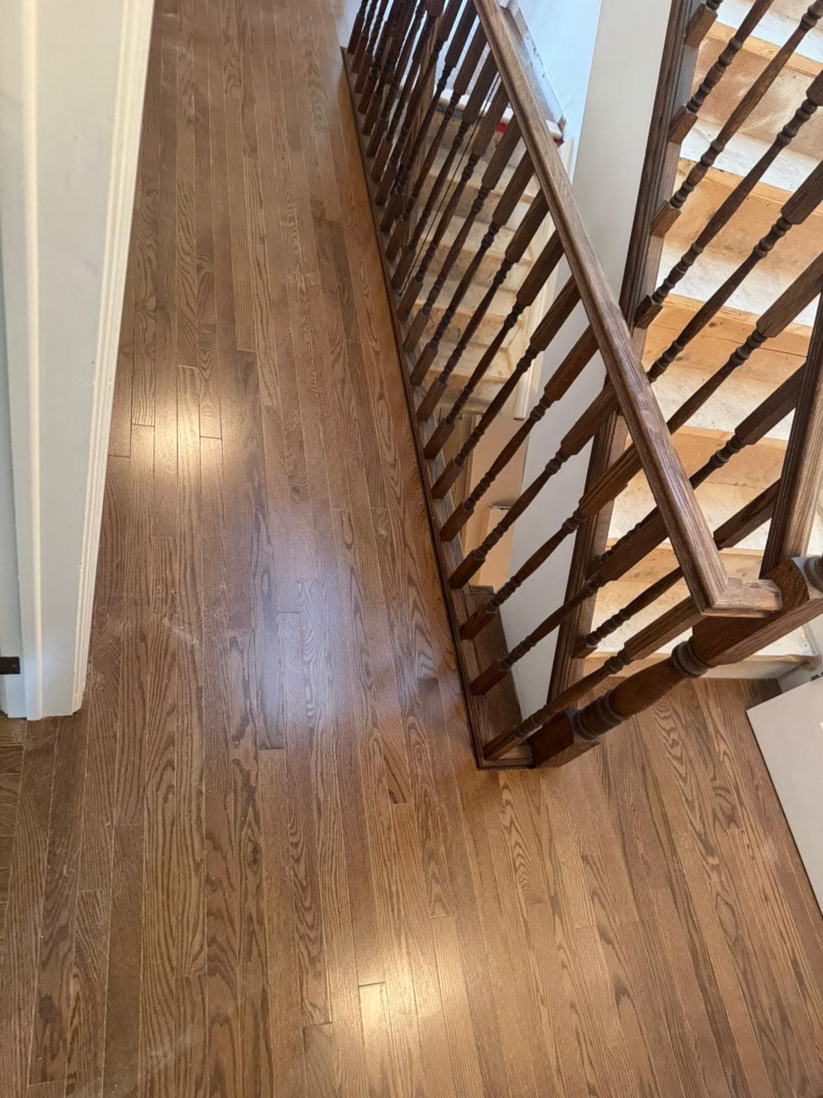 Polished hardwood flooring at a stair landing